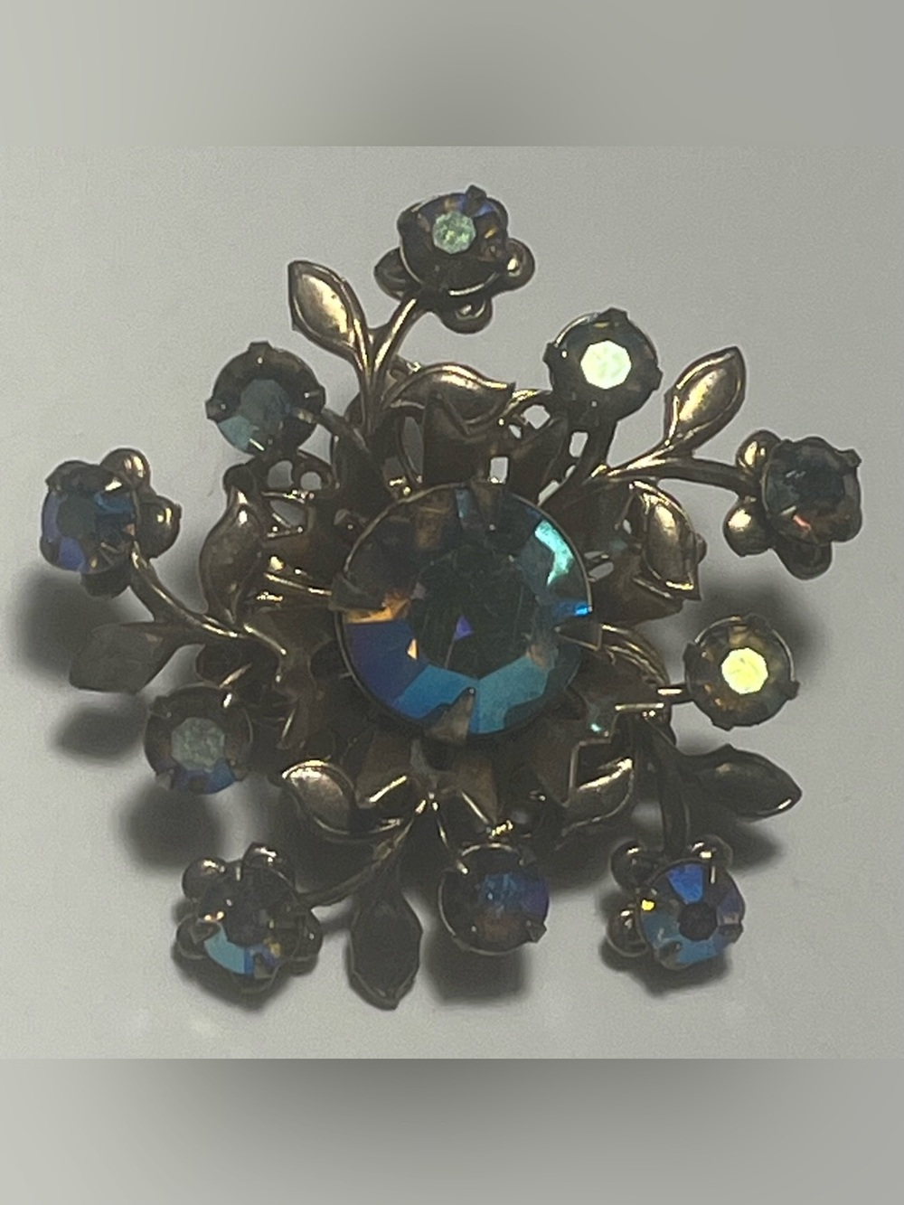 Vintage aurora borealis rhinestone brooch, gold tone snowflake/starburst design